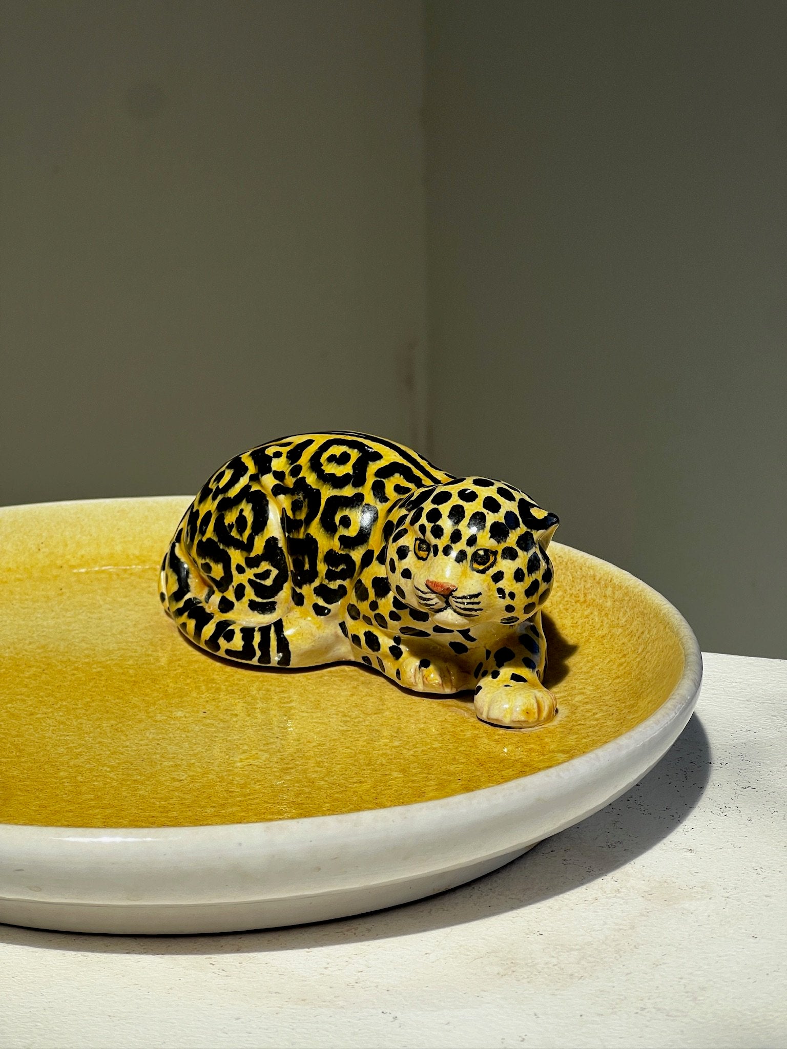 Vintage Italian Ceramic Yellow Platter with Jaguar Figurine on display for home decor. hommes + gardens estudio.