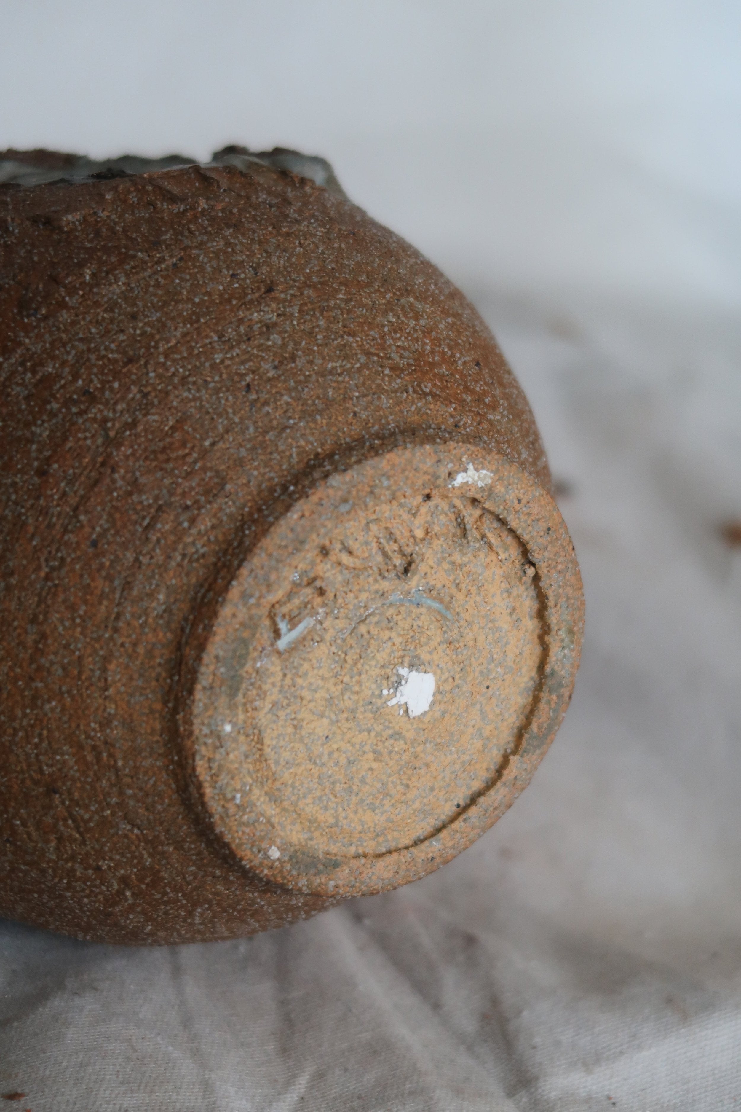 Bottom view of Signed Mid-Century Brutalist Stoneware Vase showcasing unique texture and artist signature. hommes + gardens estudio.