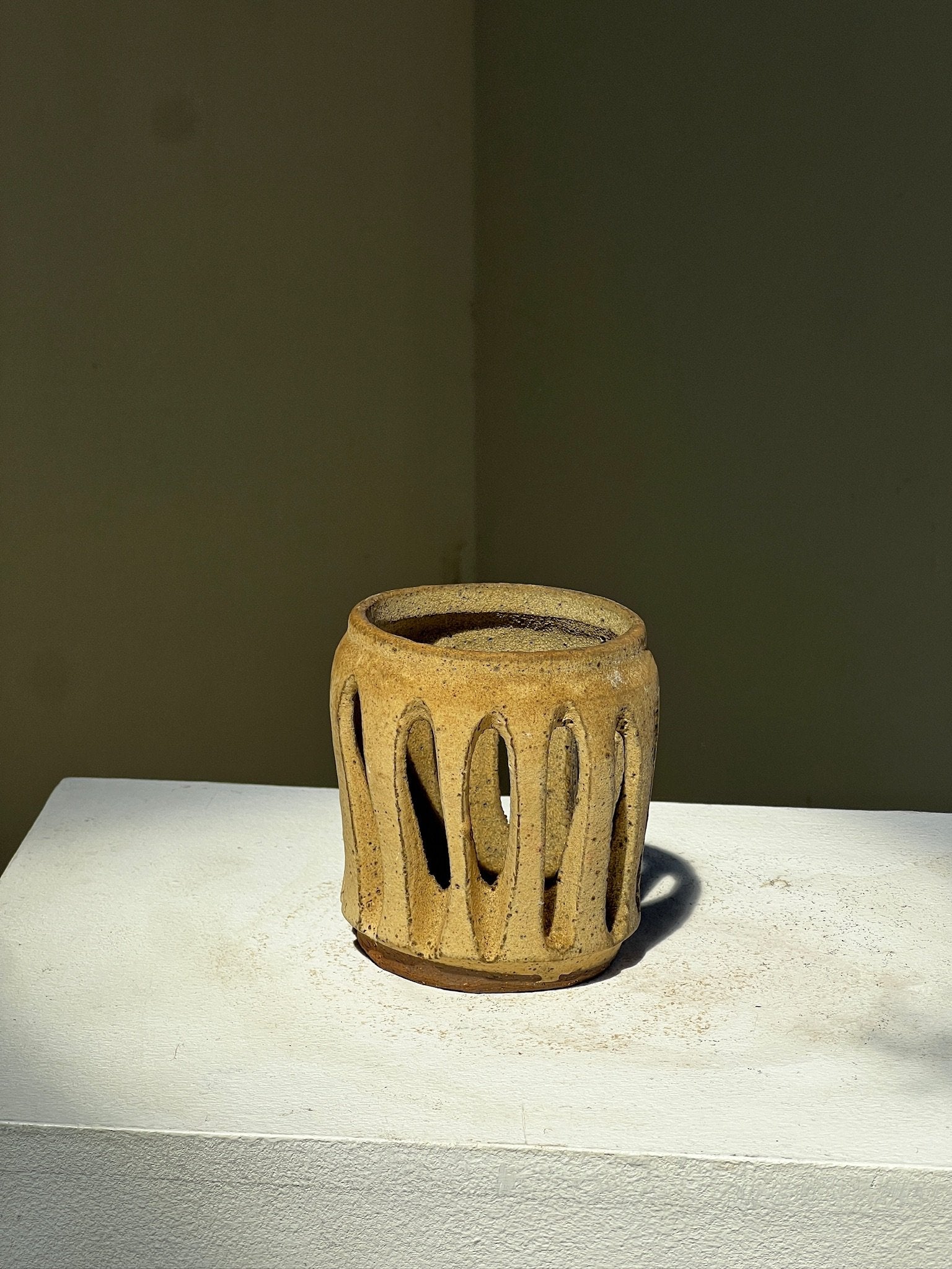 Slab pottery, lantern with organic openings showcasing rustic charm and earthy tones, adding warmth to any space. hommes + gardens estudio.