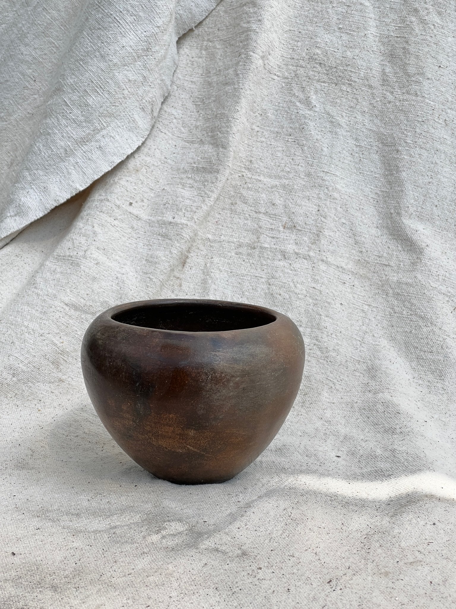 Small Vintage Dark Brown Clay Vase showcasing rich organic character, perfect for elegant home decor. hommes + gardens estudio.