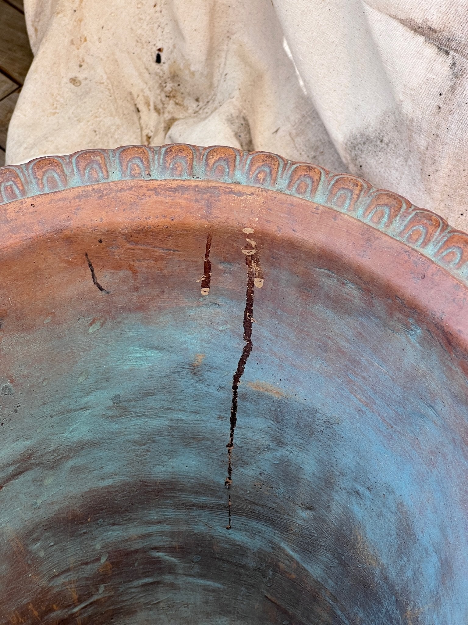Close-up of the Silvestri Terracotta Ornate Planter (Set of 2) showing intricate detail and a vintage finish. hommes + gardens estudio.