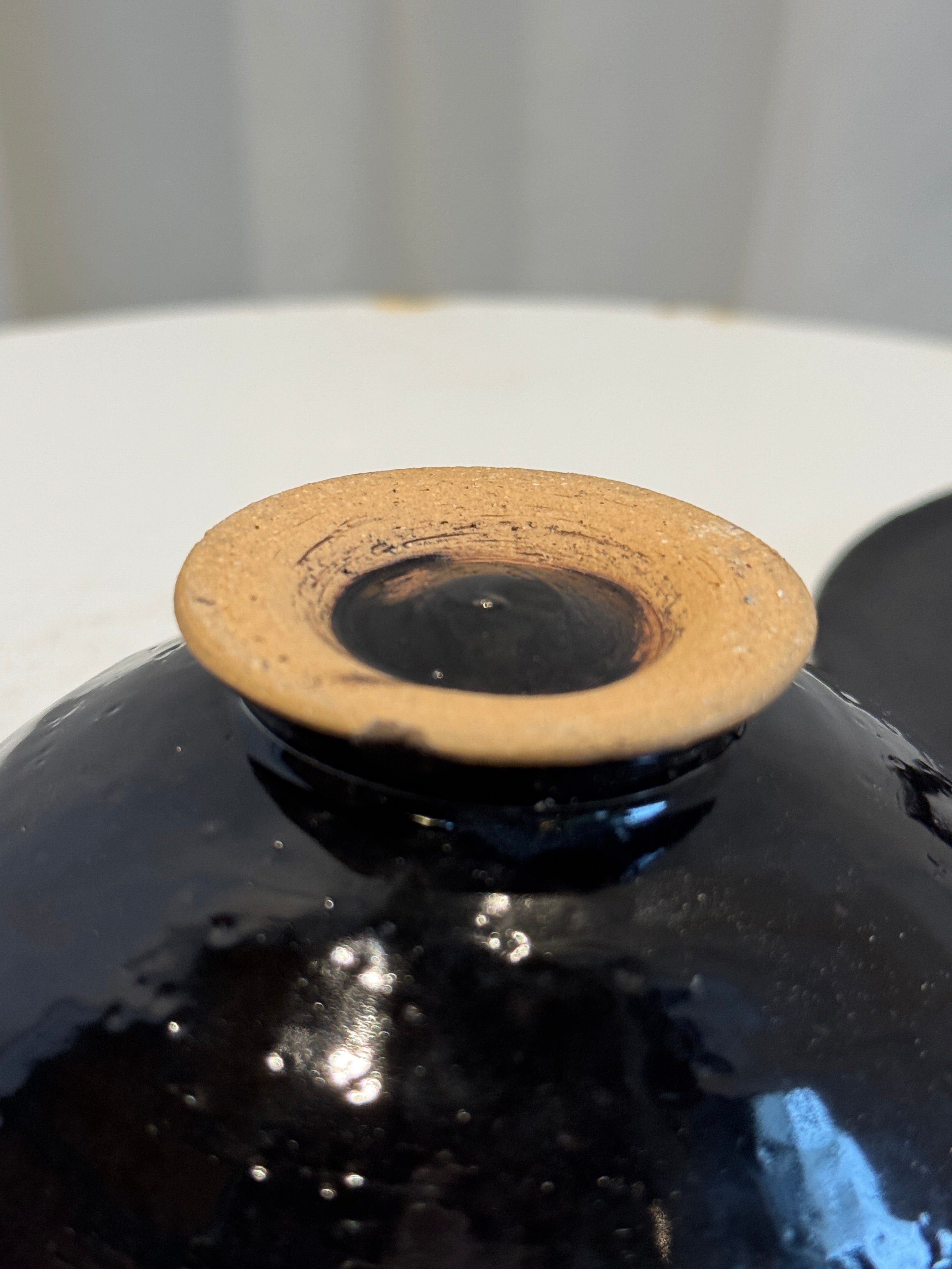 Handcrafted vintage black ceramic bowl with lid and sculptural ring handle, glossy glaze and earthy tones combining artistry and utility — Hommes and Gardens, Catchall Collection, Landscape Architect, Interior Designer, Outdoor Living, Art, Furniture, Objects, Best Gifts, Nature, Backyard, Yard, Outdoor Decorations, Home Decor, Home Design, Luxury Design.