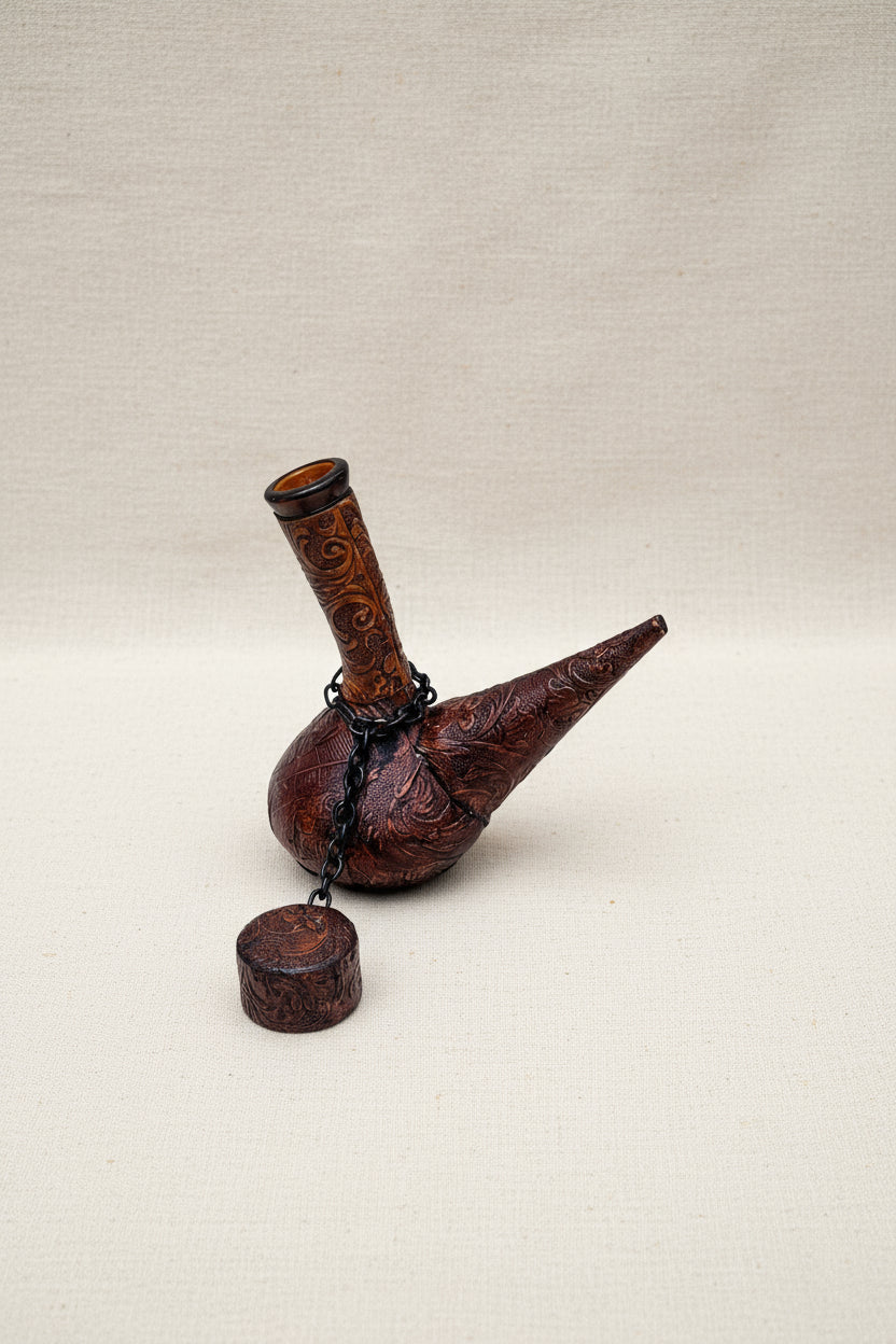 Vintage Leather Covered Wine Decanter with ornate design and leather wrap, 8” H x 7.5” L x 3.5” W, hommes + gardens estudio.