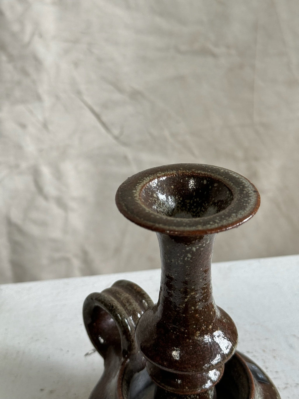 Close-up of Vintage Brown Ceramic Stoneware Candle Holder showcasing its rich dark brown hue and timeless design. hommes + gardens estudio.