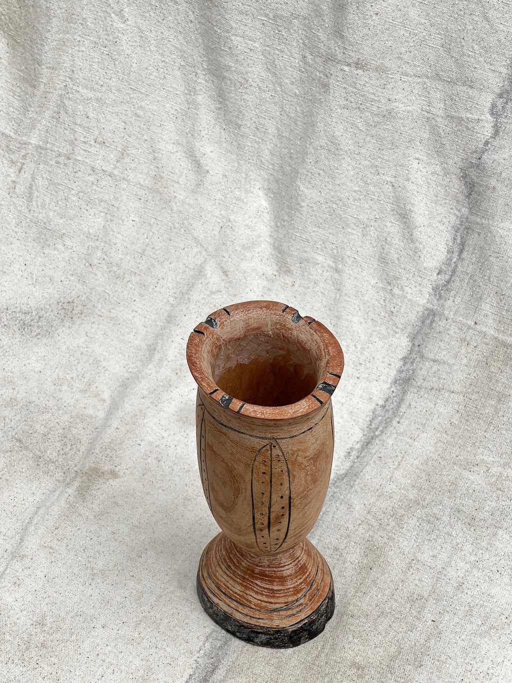 Pair of Vintage Wooden Goblets with Hand Carved Primitive Illustrations on a textured surface, hommes + gardens estudio.