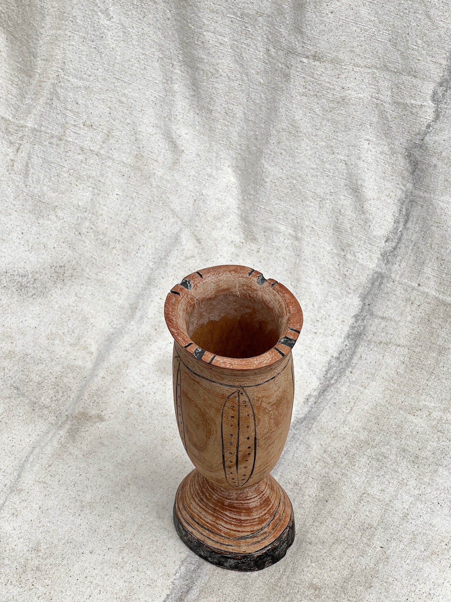 Pair of Vintage Wooden Goblets with Hand Carved Primitive Illustrations on a textured surface, hommes + gardens estudio.