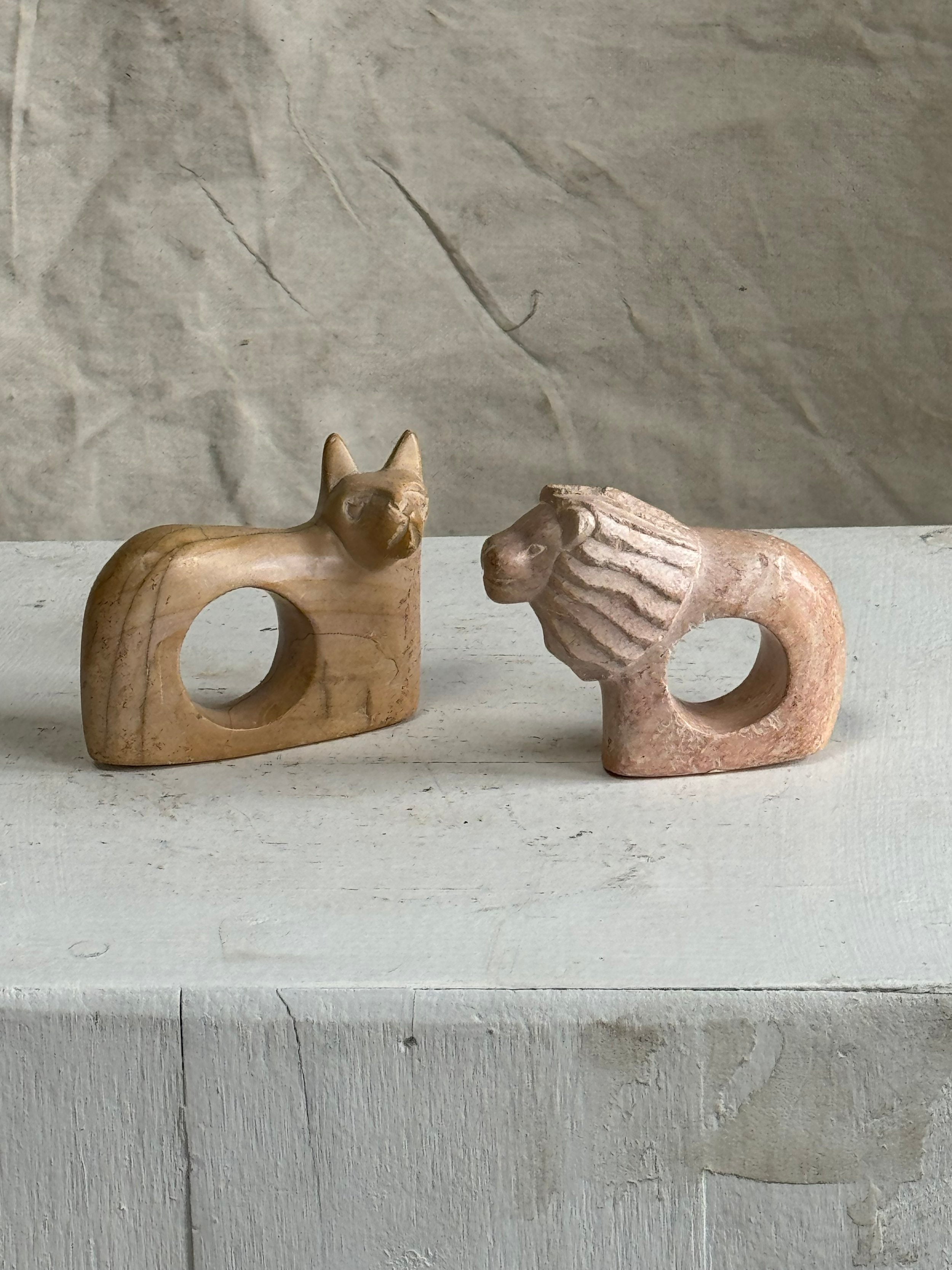 Handmade Kenyan soapstone cat and lion napkin rings, set of two carved African pieces celebrating wildlife artistry and cultural heritage — Hommes and Gardens, Fauna Collection, Landscape Architect, Interior Designer, Outdoor Living, Outdoor Decorations, Home Decor, Home Design, Luxury Design, Art, Furniture, Objects, Best Gifts, Nature, Backyard, Yard.