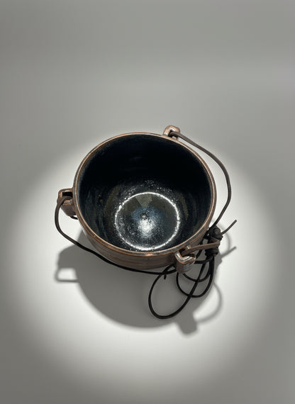 Side view of 1972 Karroll Studio Pottery hanging planter showing forged metal brackets and original leather cords — Hommes and Gardens, Pots + Vessels Collection, landscape design, plant design, Landscape Architect, Interior Designer, Outdoor Living, Outdoor Decorations, Home Design, Luxury Design, Art, Furniture, Objects, Best Gifts, Nature, Backyard, Yard.