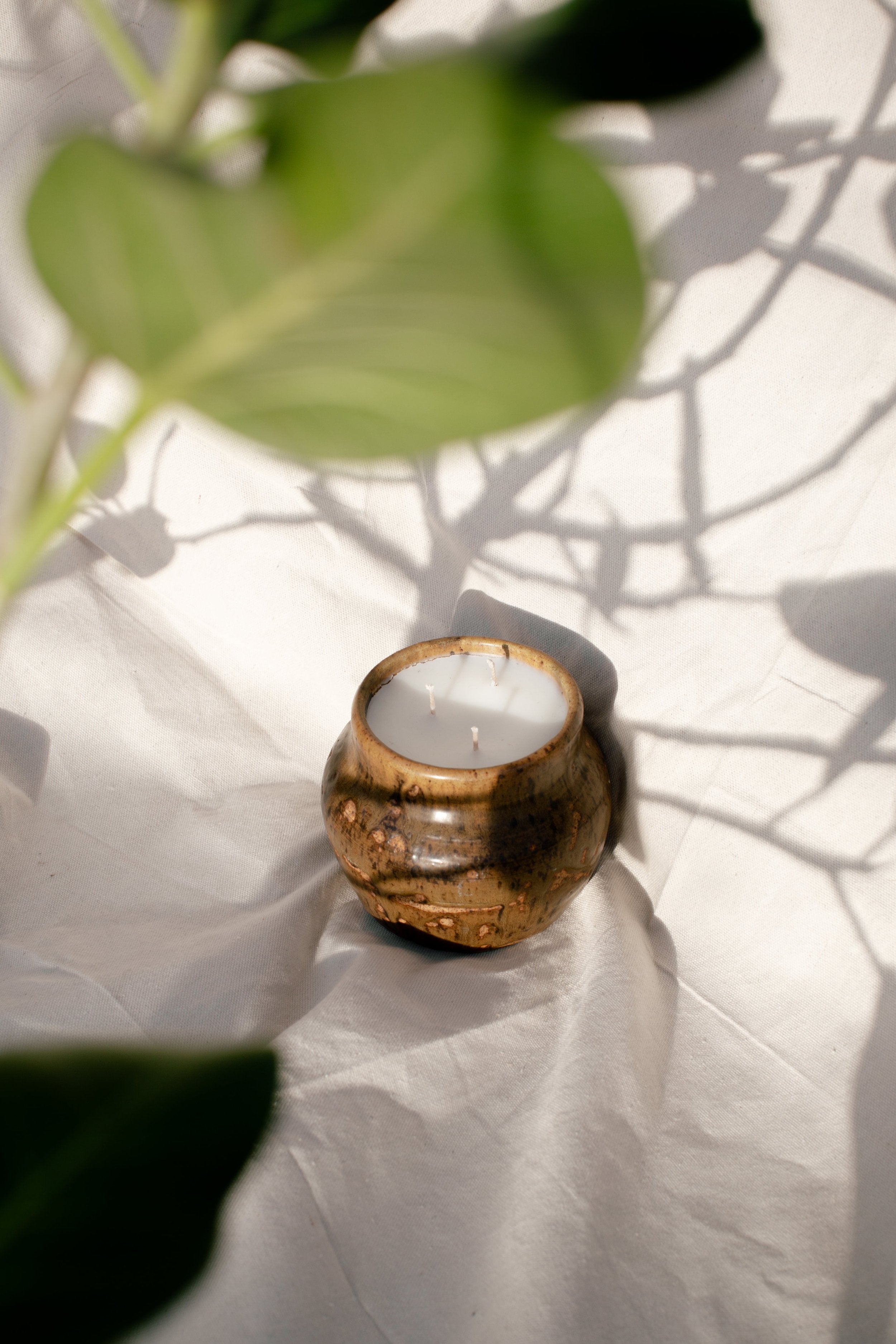 Vintage Handmade Ceramic Vase | H&G x Western Disco on textured surface with plant shadow, hommes + gardens estudio.