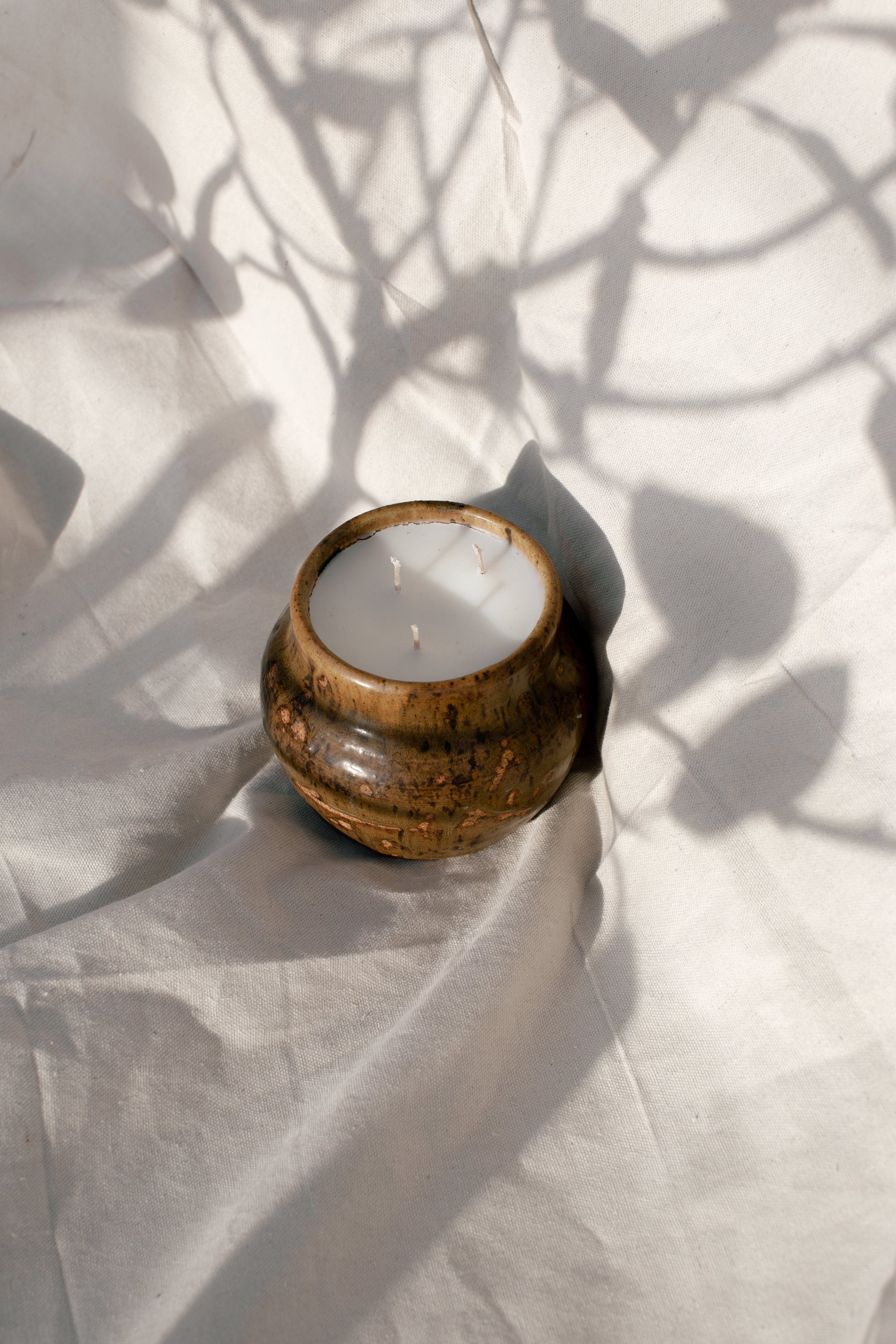 Vintage Handmade Ceramic Vase | H&G x Western Disco on fabric with shadows, showcasing a unique design. hommes + gardens estudio.