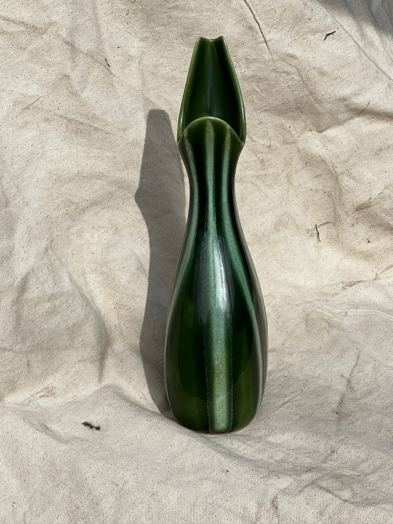 Vintage Hull Art Pottery # 54 - Continental Line Vase Evergreen color displayed on fabric background. hommes + gardens estudio.