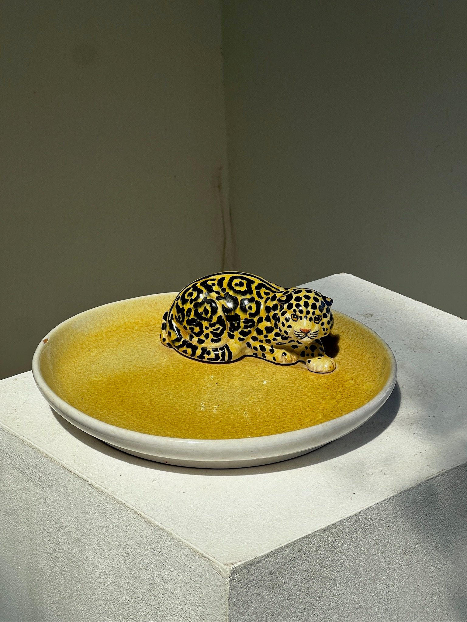 Vintage Italian Ceramic Yellow Platter with Jaguar Figurine showcasing a detailed jaguar on a vibrant yellow surface. hommes + gardens estudio.