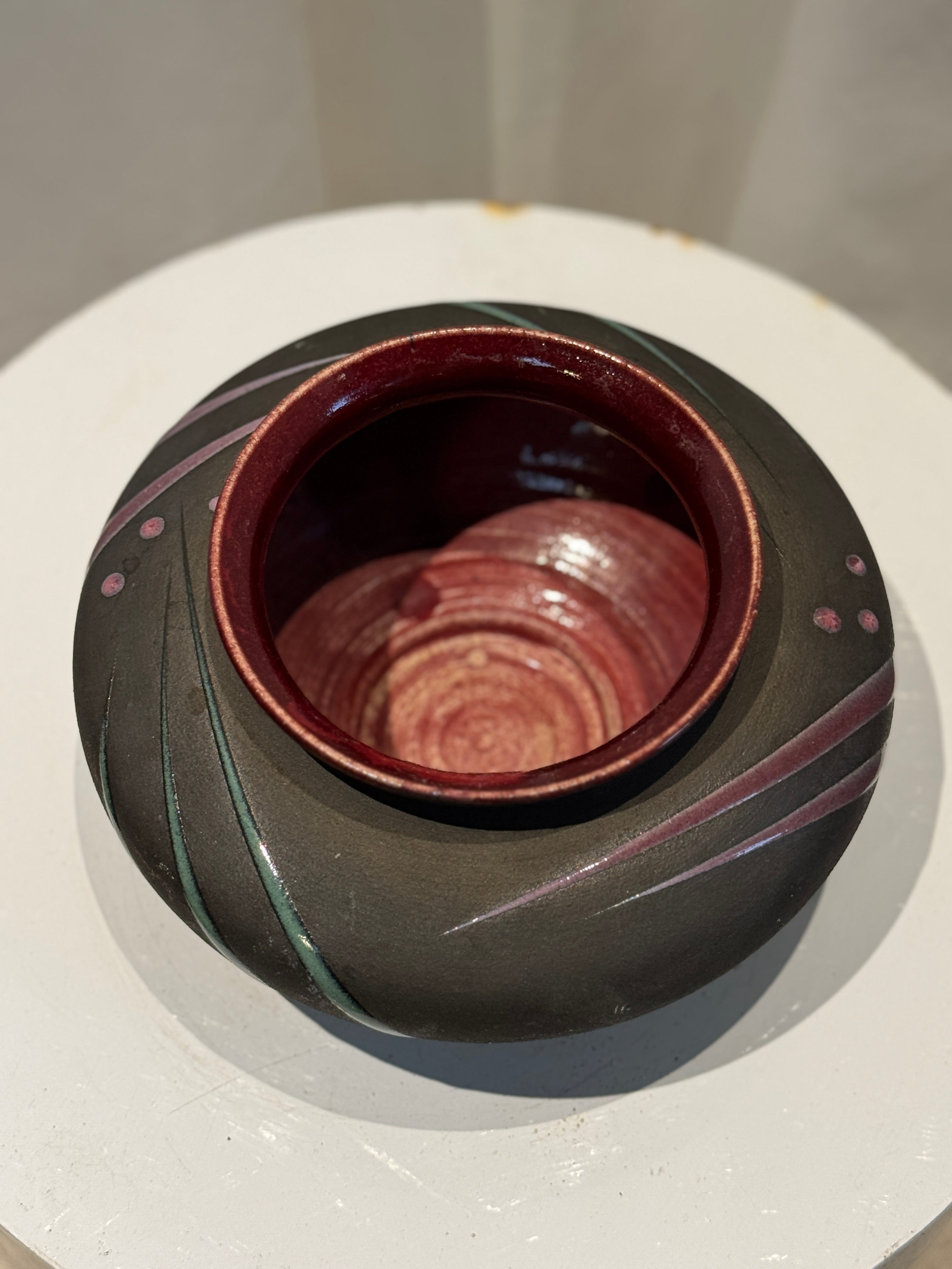 Michael Cho handmade studio pottery vase in modern ceramic art style, featuring flowing maroon and green motifs on charcoal gray with glossy burgundy interior — Hommes and Gardens, Vases + Vessels Collection, Landscape Architect, Interior Designer, Outdoor Living, Art, Furniture, Objects, Best Gifts, Nature, Backyard, Yard, Outdoor Decorations, Home Decor, Home Design, Luxury Design.