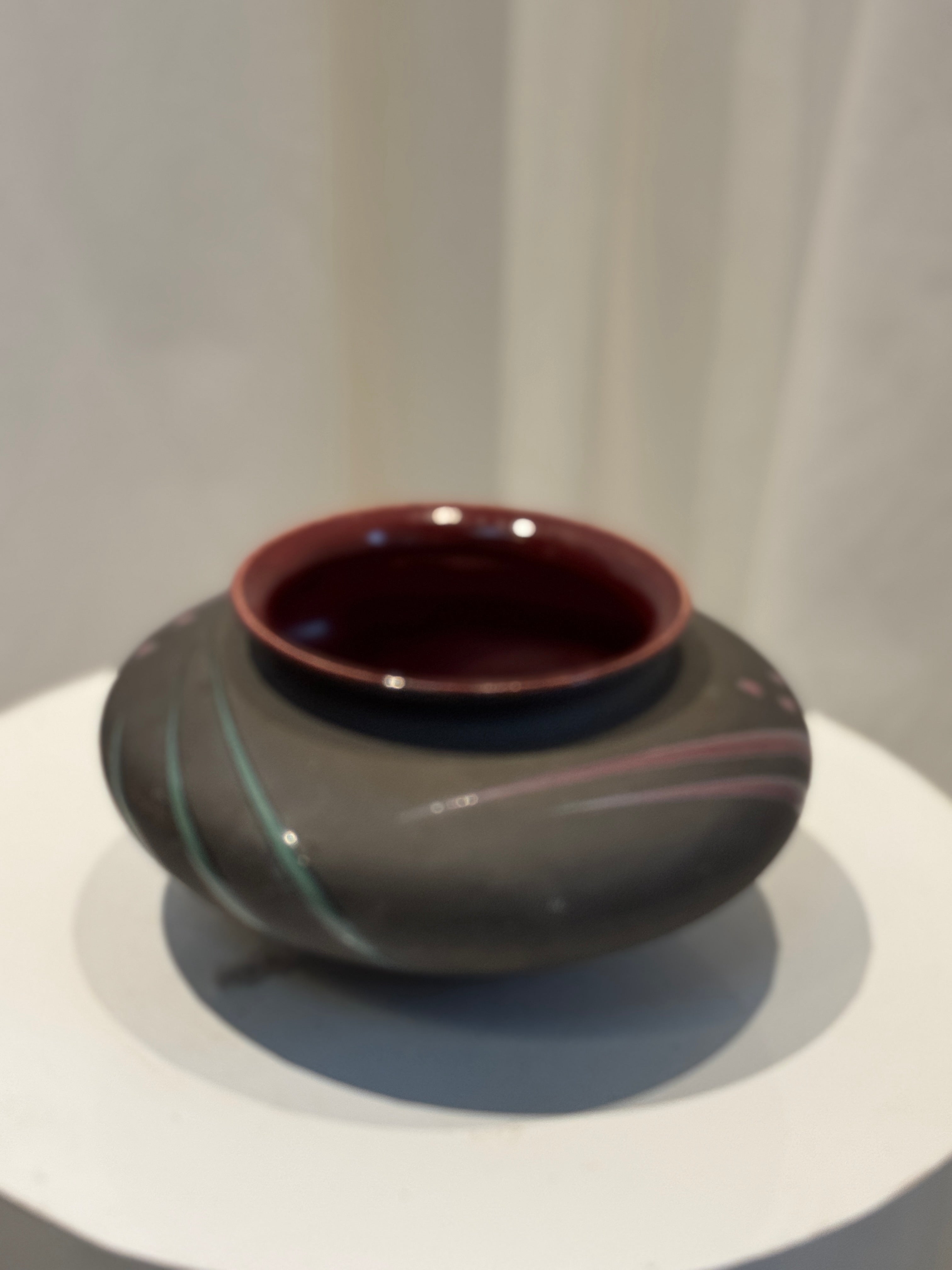 Michael Cho studio art pottery vase, handcrafted ceramic vessel with maroon and green hand-painted accents on a charcoal gray base and burgundy-glazed interior — Hommes and Gardens, Vases + Vessels Collection, Landscape Architect, Interior Designer, Outdoor Living, Art, Furniture, Objects, Best Gifts, Nature, Backyard, Yard, Outdoor Decorations, Home Decor, Home Design, Luxury Design.