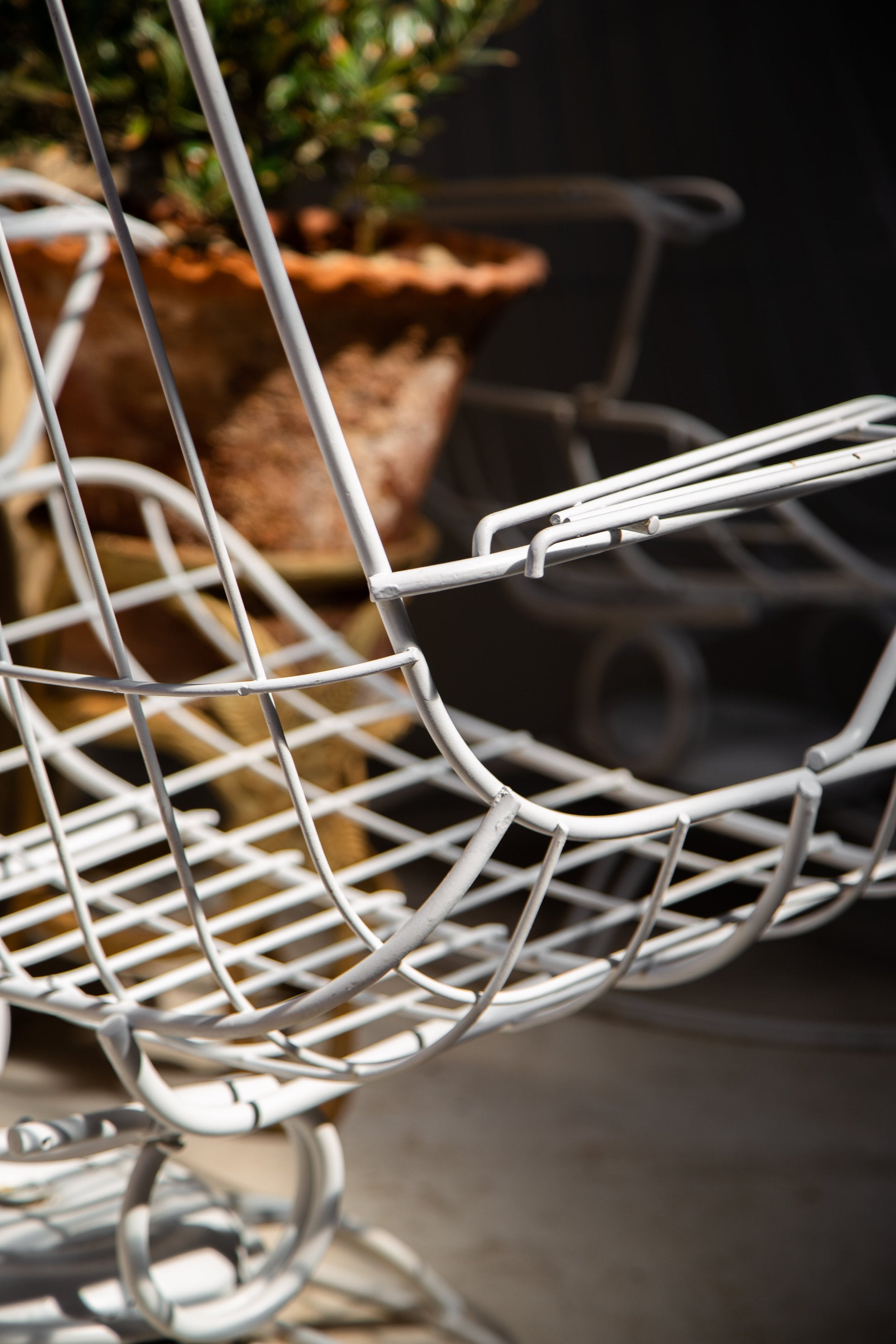 Close-up of Pair of Mid-Century Modern Homecrest Siesta Swivel Rocker Patio Lounge Chairs highlighting unique design detail. hommes + gardens estudio.