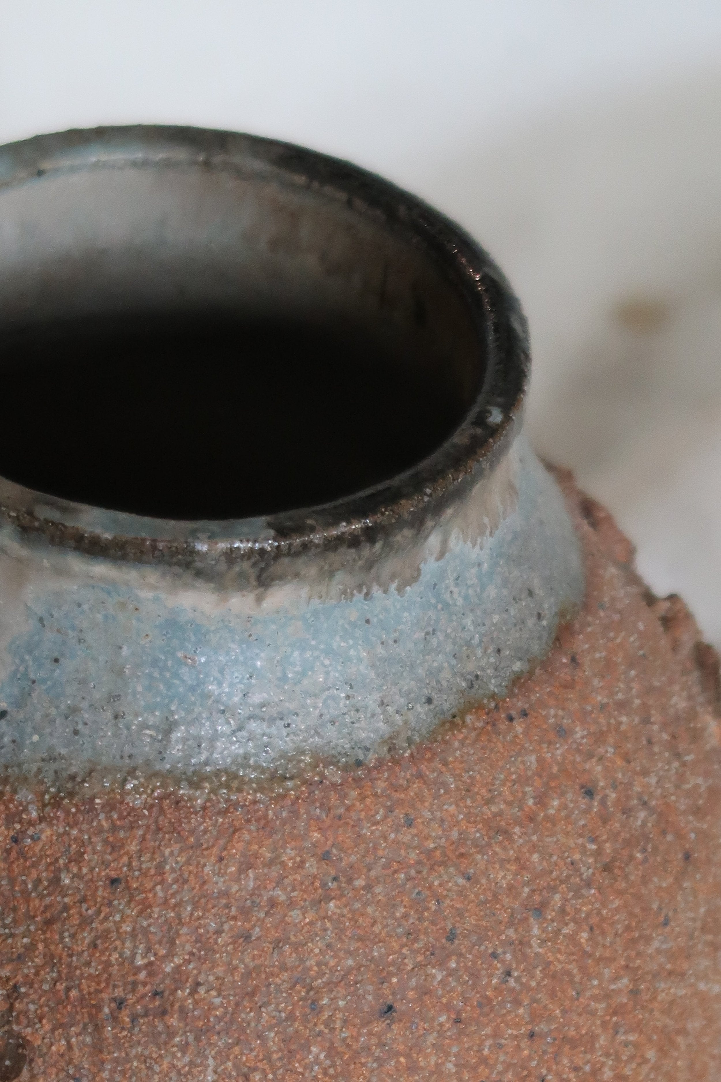 Close-up view of the top of a Signed Mid-Century Brutalist Stoneware Vase highlighting its raw texture. hommes + gardens estudio.