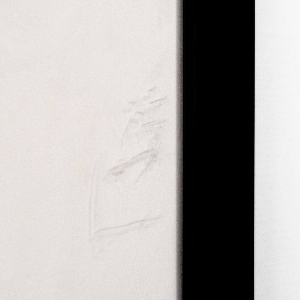 Close-up of the edge of a frame showing a subtle imperfection, possibly a scratch or smudge. hommes + gardens estudio.