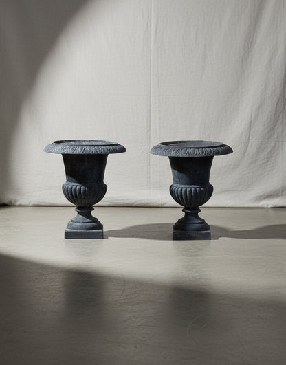 Pair of early 20th-century French Neoclassical cast iron urn planters with antique charcoal patina, exuding timeless elegance for indoor or outdoor spaces — Hommes and Gardens, Pots + Vessels Collection, Landscape Architect, Interior Designer, Outdoor Living, Outdoor Decorations, Home Decor, Home Design, Luxury Design, Art, Furniture, Objects, Best Gifts, Nature, Backyard, Yard.