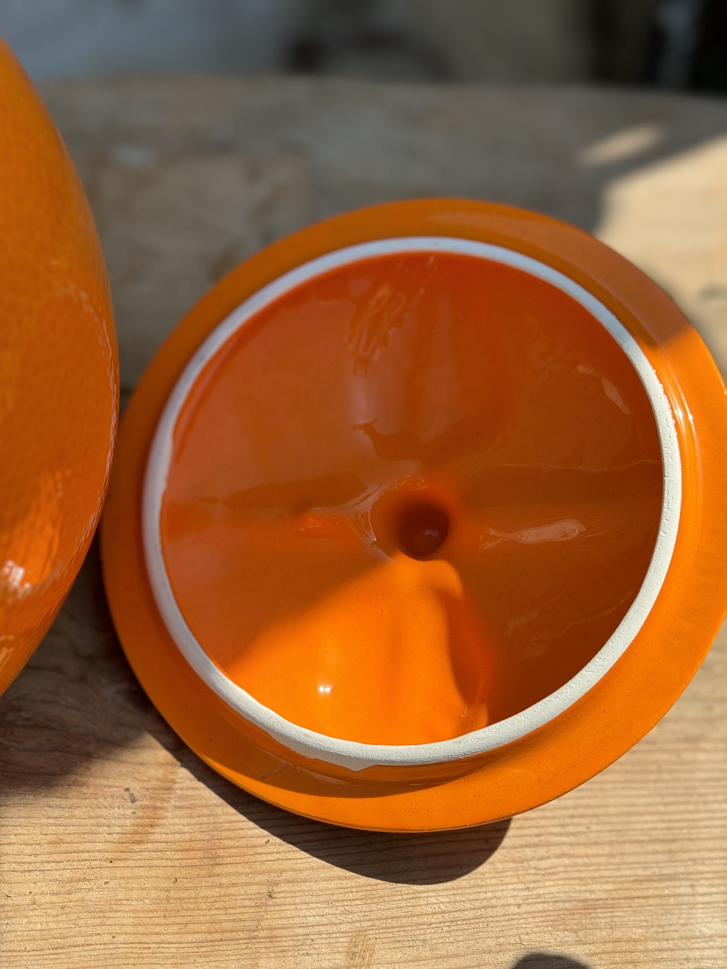 Inside view of Retro Orange-Shaped Cookie Jar - Vintage Kitsch showcasing the vibrant orange color and design details. hommes + gardens estudio