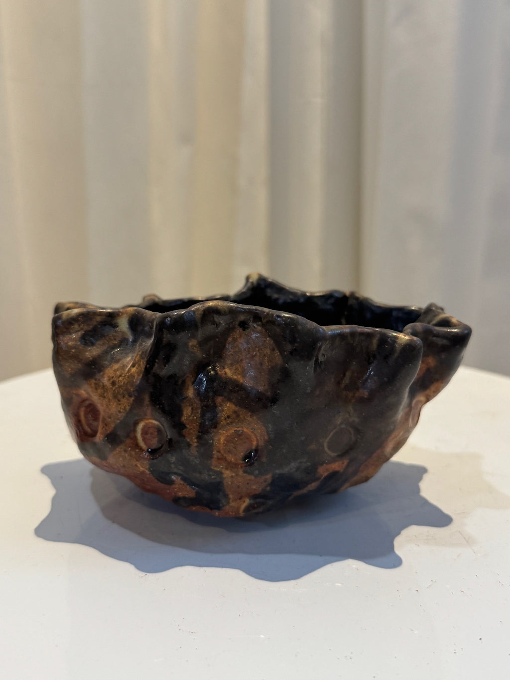 Organic studio pottery vase, handmade with undulating rim and black-brown glaze accented by amber highlights, celebrating natural imperfection — Hommes and Gardens, Vases + Vessels Collection, Landscape Architect, Interior Designer, Outdoor Living, Art, Furniture, Objects, Best Gifts, Nature, Backyard, Yard, Outdoor Decorations, Home Decor, Home Design, Luxury Design.