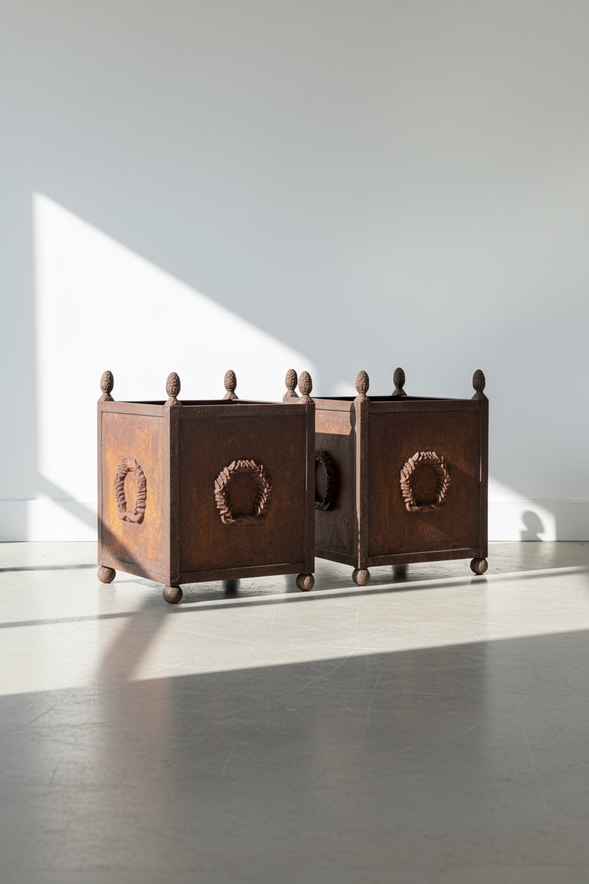 Pair of American Neoclassical style corten metal planters with laurel wreaths, acorn tops, and aged patina, crafted in the 20th century — Hommes and Gardens, Pots + Vessels Collection, Landscape Architect, Interior Designer, Outdoor Living, Outdoor Decorations, Home Decor, Home Design, Luxury Design, Art, Furniture, Objects, Best Gifts, Nature, Backyard, Yard.