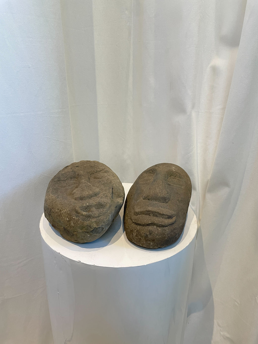 Primitive stone face sculptures handcrafted from natural stone, evoking indigenous art and cultural expression — Hommes and Gardens, home decor, garden decor, outdoor decorations, home design, luxury design, Landscape Architect, Interior Designer, Outdoor Living, Art, Furniture, Objects, Best Gifts, Nature, Backyard, Yard.