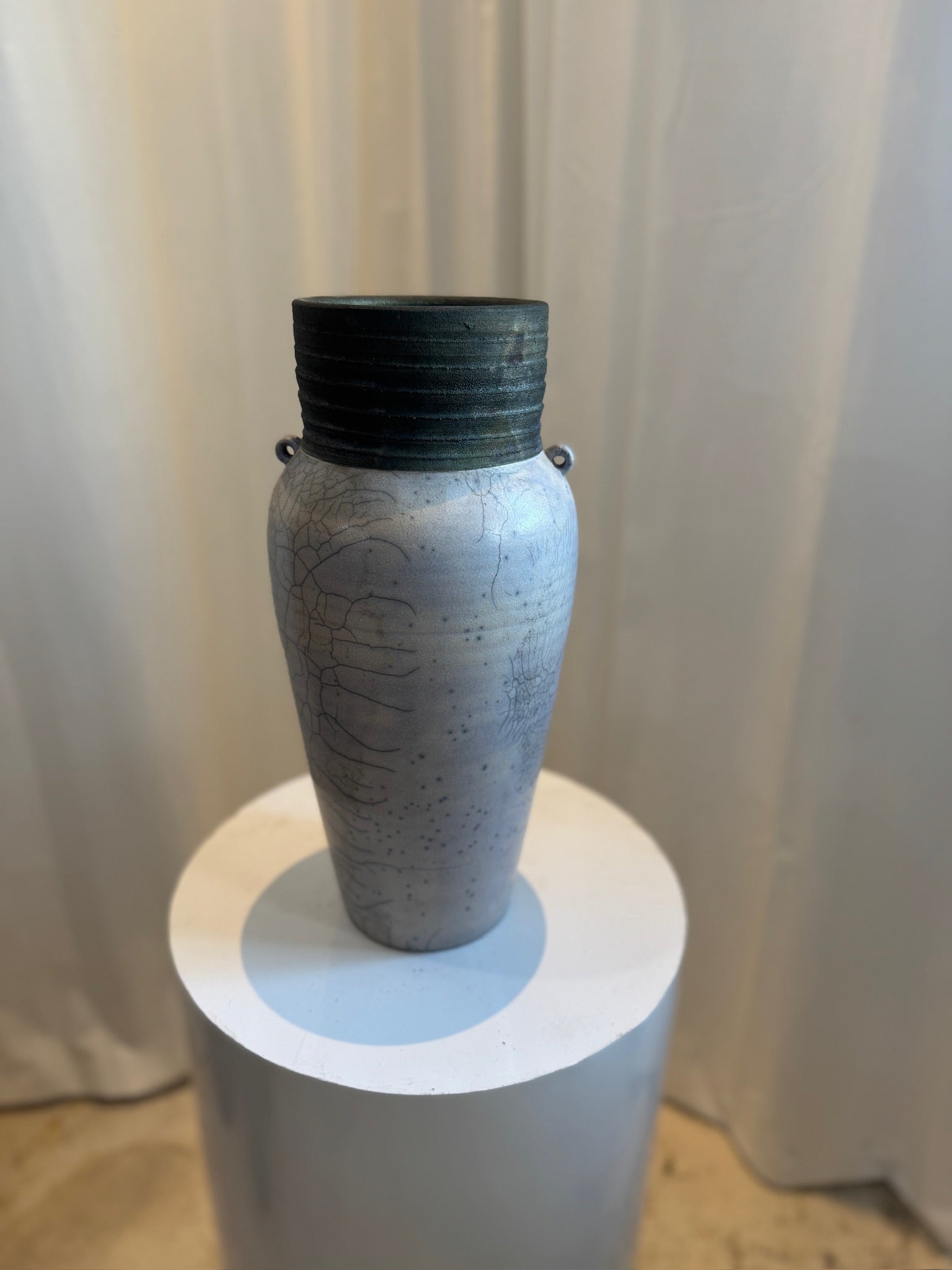 Raku handcrafted ceramic vase with crackled glaze, ribbed rim, and drainage hole, featuring organic textures and loop handles for artistic display — Hommes and Gardens, Vases + Vessels Collection, Landscape Architect, Interior Designer, Outdoor Living, Art, Furniture, Objects, Best Gifts, Nature, Backyard, Yard, Outdoor Decorations, Home Decor, Home Design, Luxury Design.