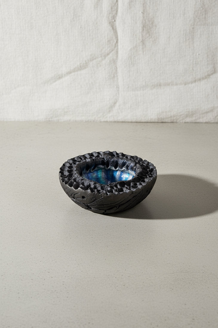 Raku Lava Bowl Vintage Volcanic Crater by Hutch Ceramics Maui showcasing a unique black and blue design. hommes + gardens estudio.