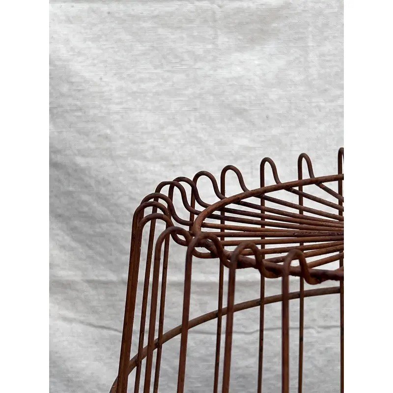 Close-up view of a Primitive Egg Gathering Wire Basket showcasing its rustic design and sturdy wire construction. hommes + gardens estudio.