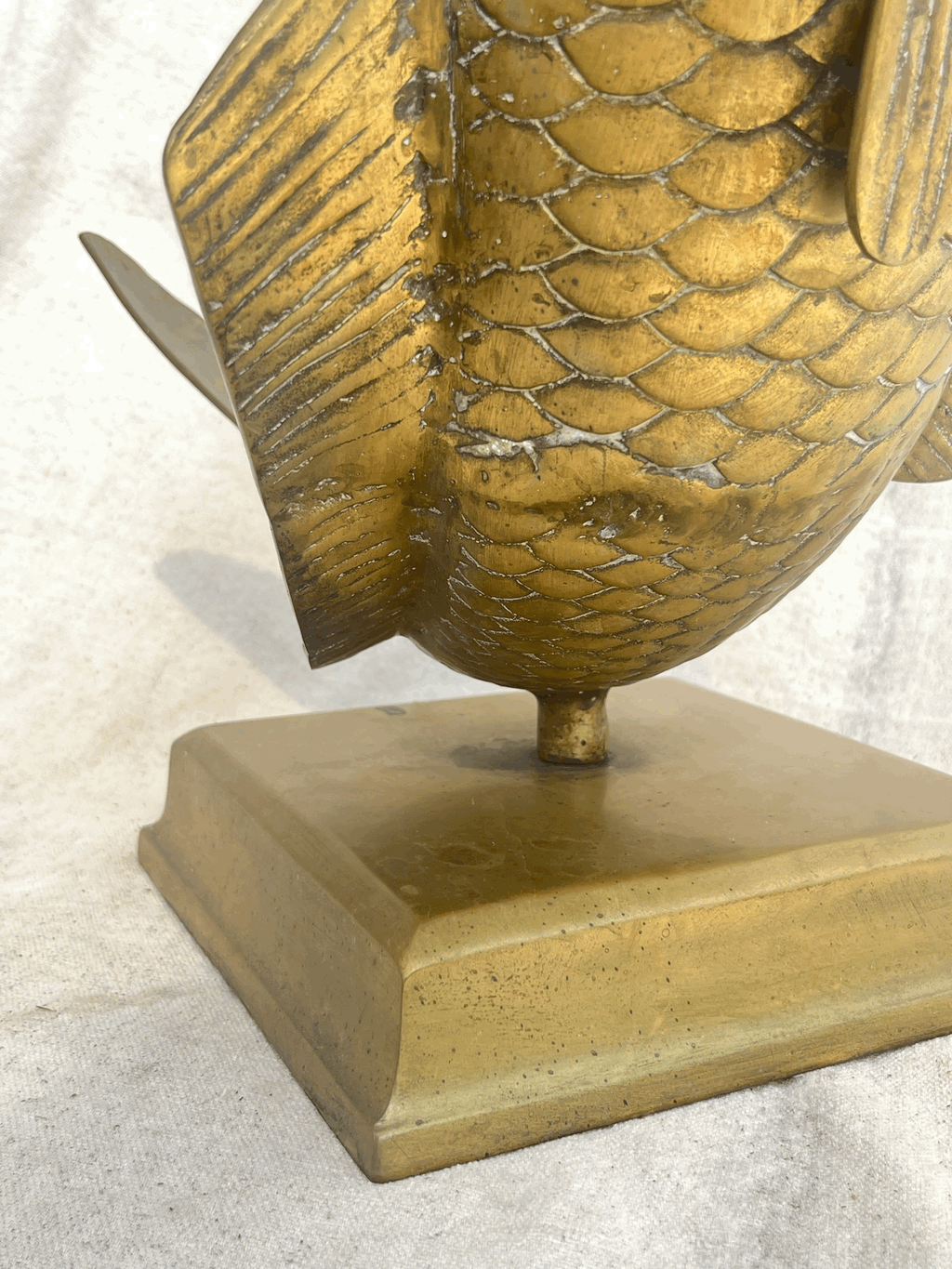 Close-up of the Solid Brass Fish Vase showcasing intricate scales, base structure, hommes + gardens estudio.