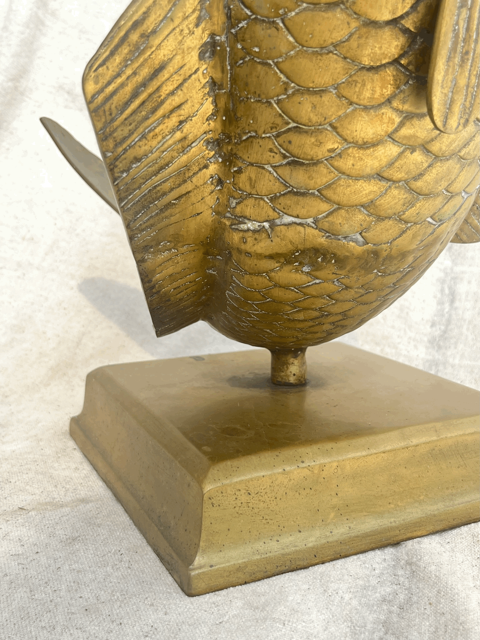 Close-up of the Solid Brass Fish Vase showcasing intricate scales, base structure, hommes + gardens estudio.