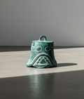 Shang Dynasty Bronze Bell with intricate engravings and mask designs, symbolizing ancient artistry. hommes + gardens estudio.