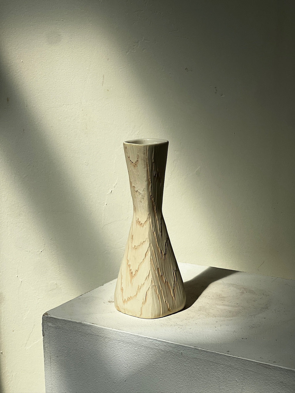 Vintage Mid Century Fairy Wood Vase by Shawnee USA on a pedestal with soft lighting, showcasing its unique design. hommes + gardens estudio.