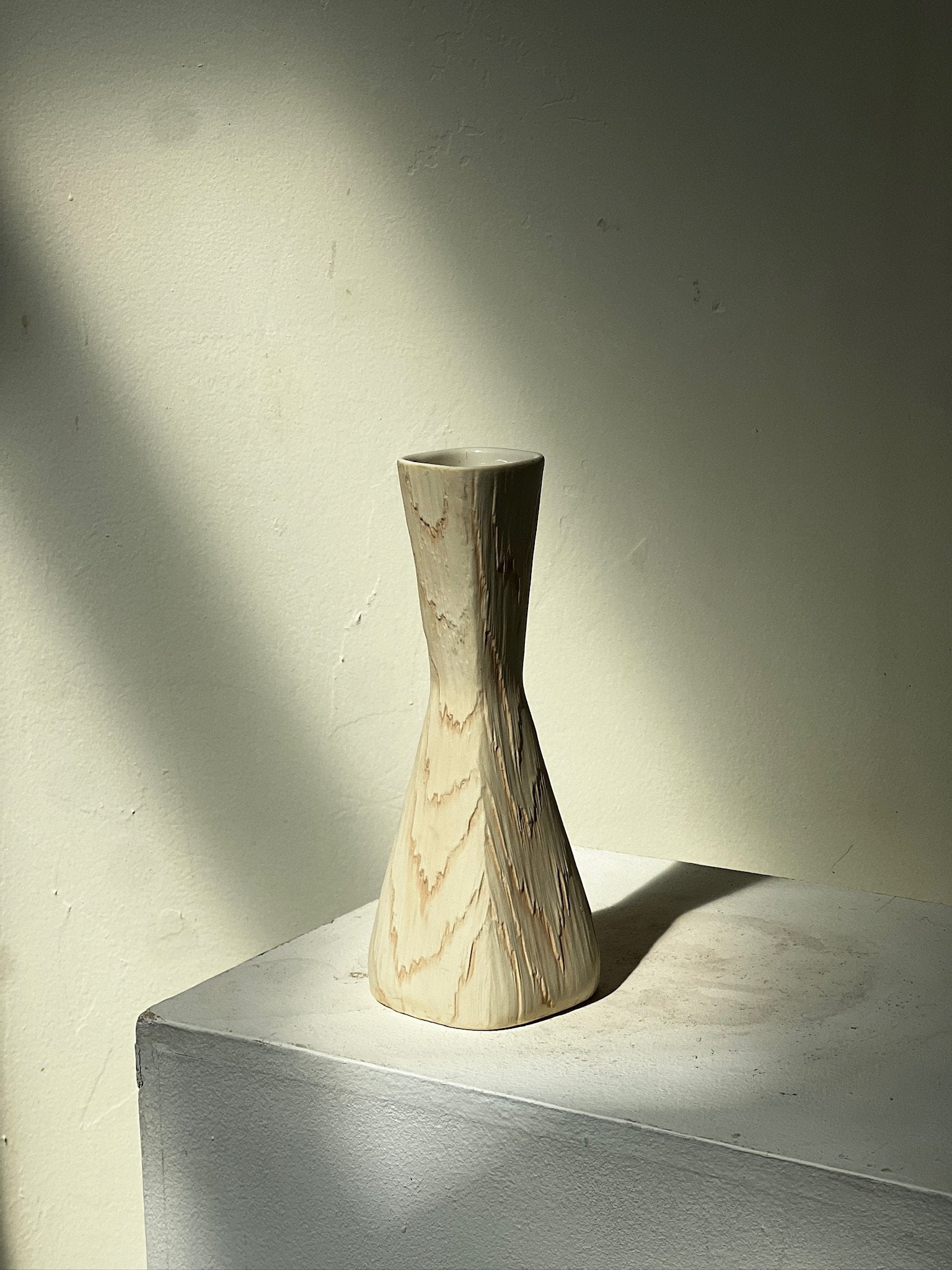 Vintage Mid Century Fairy Wood Vase by Shawnee USA on a pedestal with soft lighting, showcasing its unique design. hommes + gardens estudio.