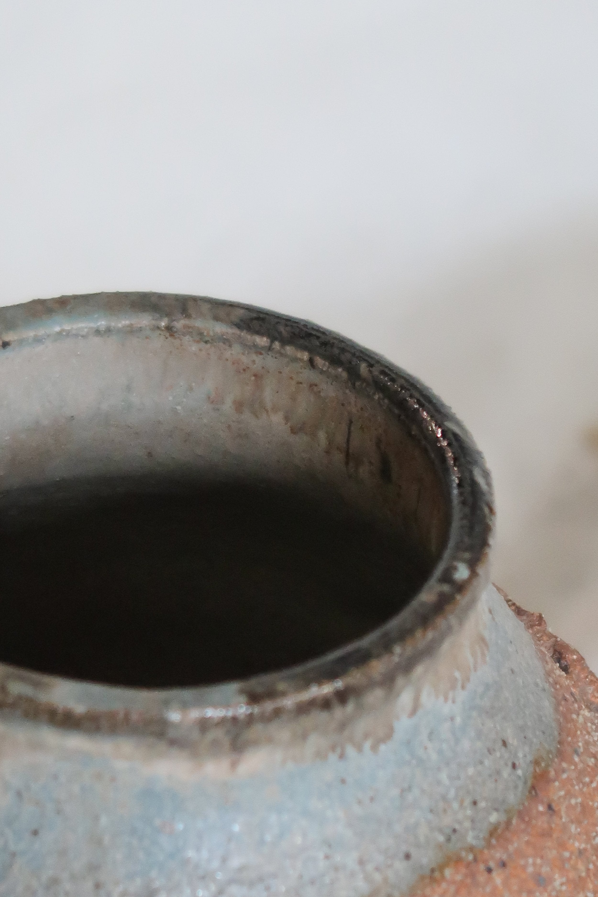 Close-up of the interior of a Signed Mid-Century Brutalist Stoneware Vase, showcasing unique texture and vintage charm. hommes + gardens estudio.