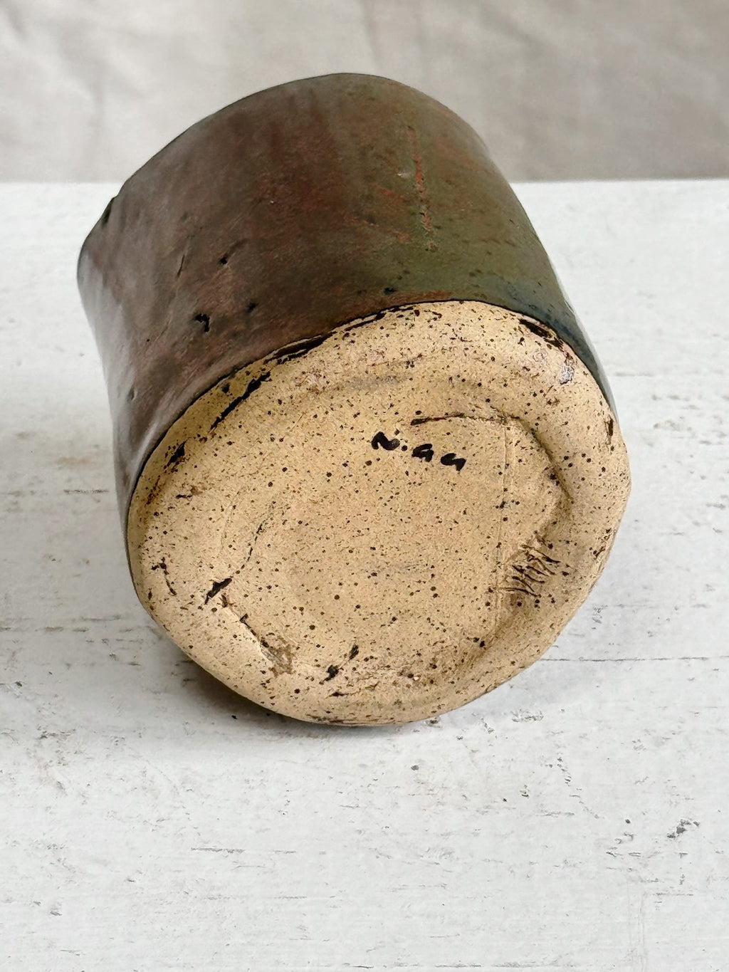 Bottom view of a Vintage Signed Handmade Glazed Ceramic Vase showcasing its unique signature and earthy glaze details. hommes + gardens estudio.