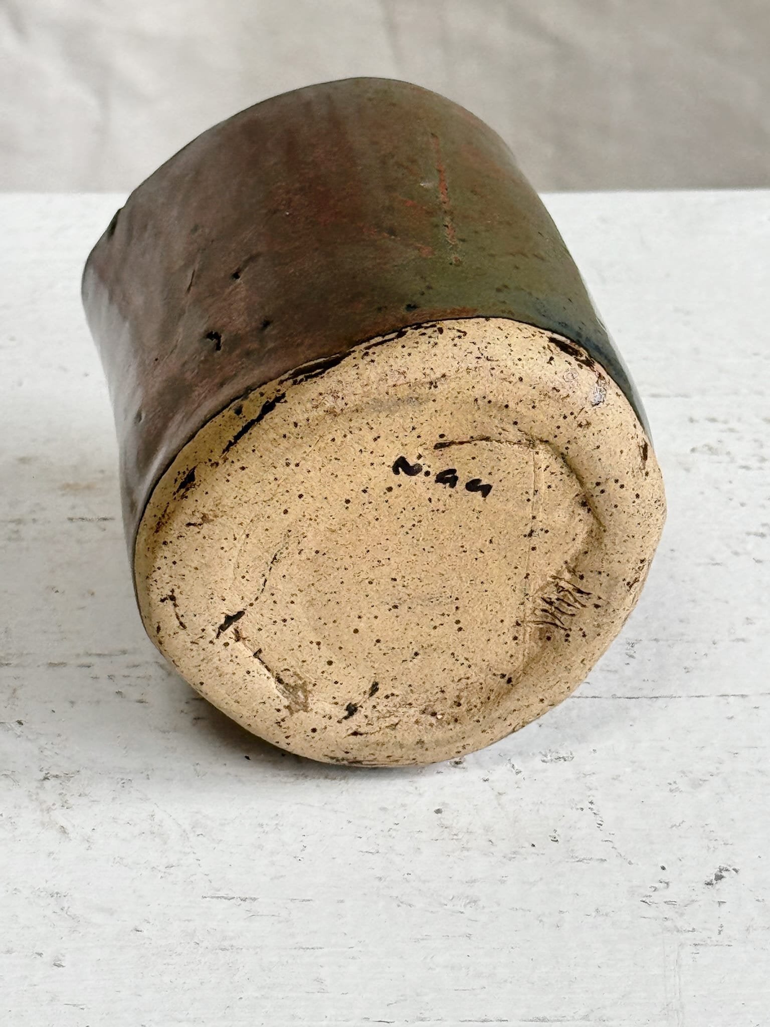 Bottom view of a Vintage Signed Handmade Glazed Ceramic Vase showcasing its unique signature and earthy glaze details. hommes + gardens estudio.