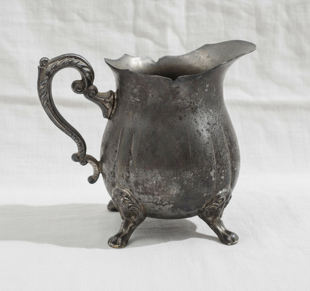 Silver Plated Footed Creamer Pitcher showcasing elegant craftsmanship and a classic design. hommes + gardens estudio