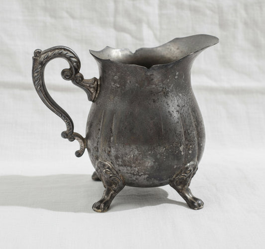Silver plated footed creamer pitcher made in Hong Kong, featuring elegant craftsmanship, spout design, and timeless shine — Hommes and Gardens, Home Decor Collection, Decorative Objects, Vintage Tableware, Silverware Art, Classic Interiors, Collectible Decor.