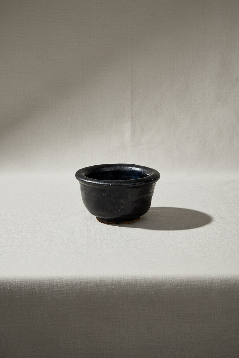 Small Black Vintage Asian Bowl on neutral background, a collectible décor piece for home styling. hommes + gardens estudio.