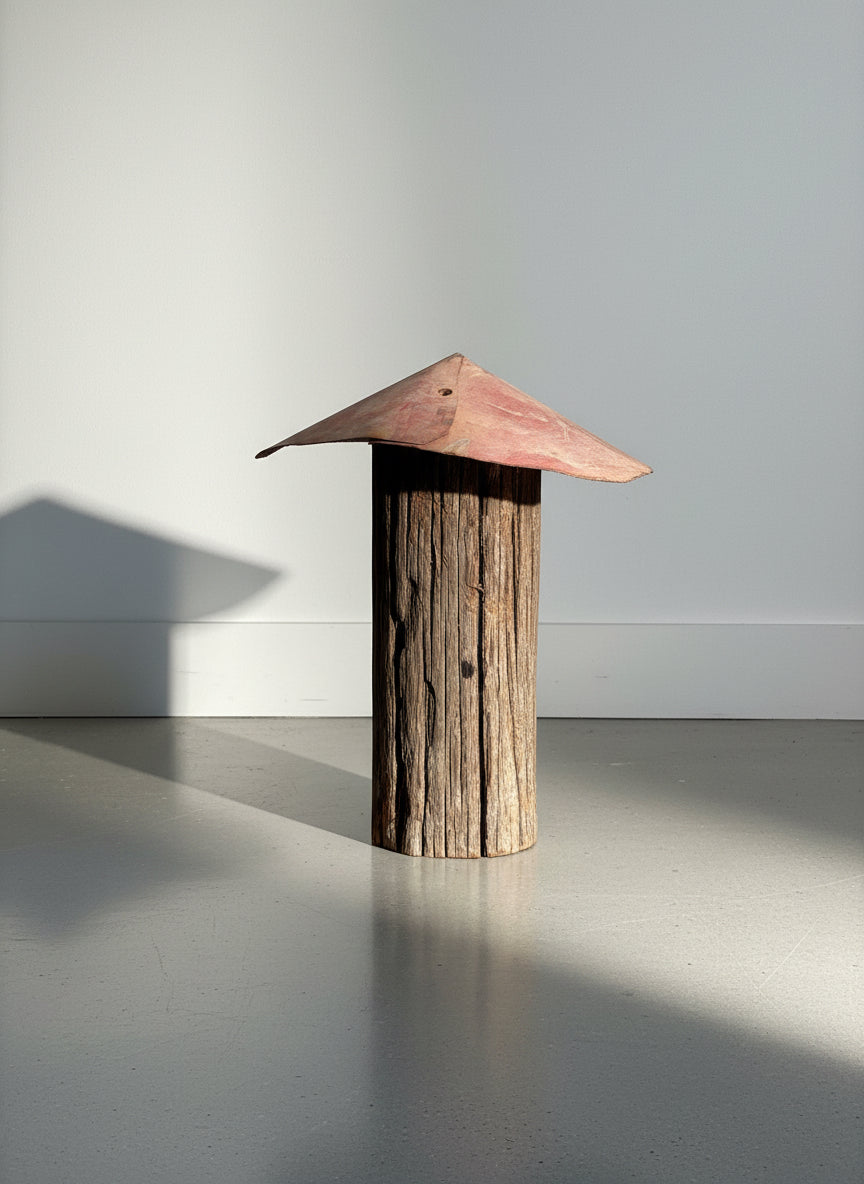 Rustic Primitive Folk Art Sculpture – Weathered Wood Post with Red Metal Roof against a light background. hommes + gardens estudio.