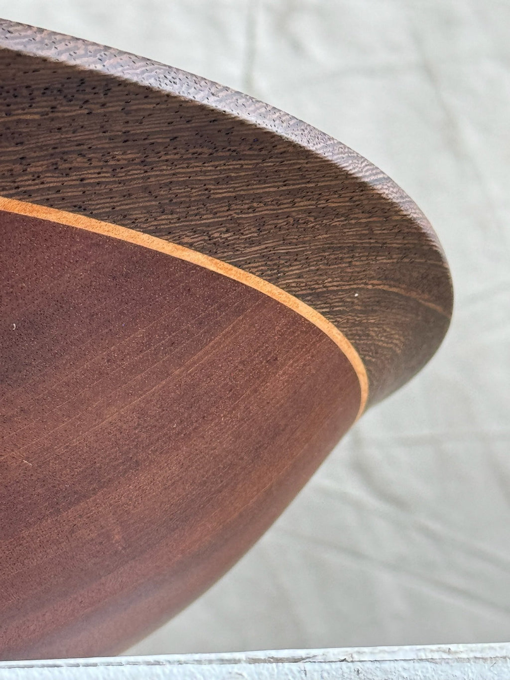 Close-up view of Vintage Mahogany Wooden Bowl showcasing the dark brown finish and golden stained wood ring. hommes + gardens estudio