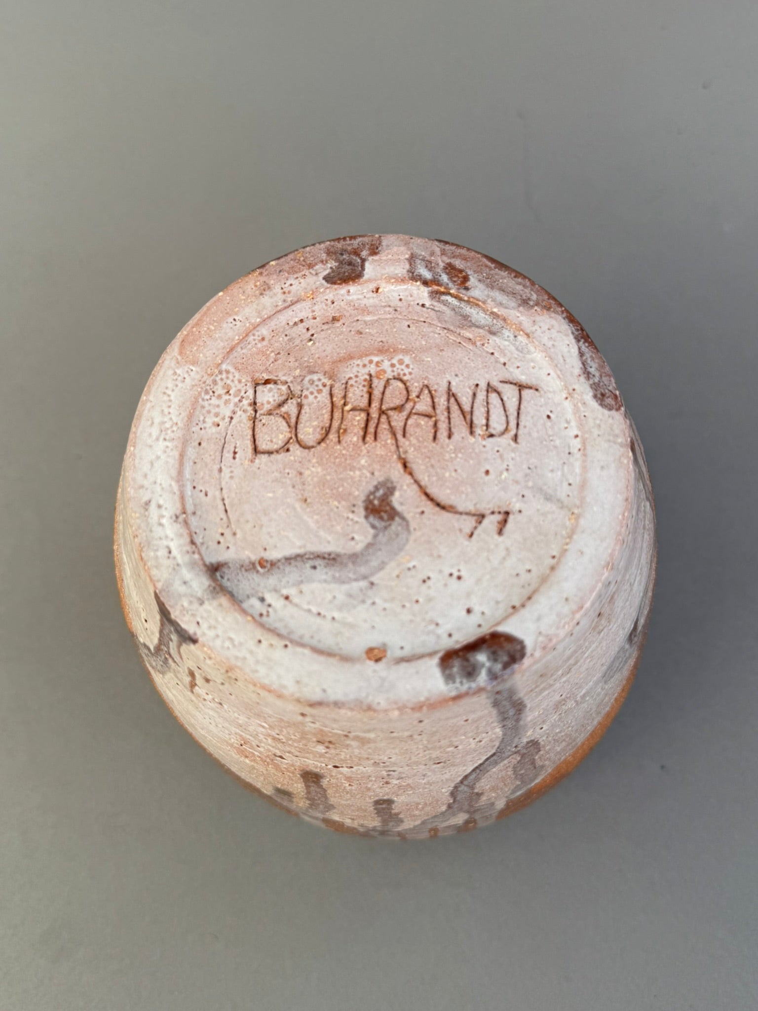 Bottom view of a Signed Buhrandt Studio Art Pottery Cup – Handcrafted Abstract Glazed Stoneware Vessel showcasing the artist's signature. hommes + gardens estudio.
