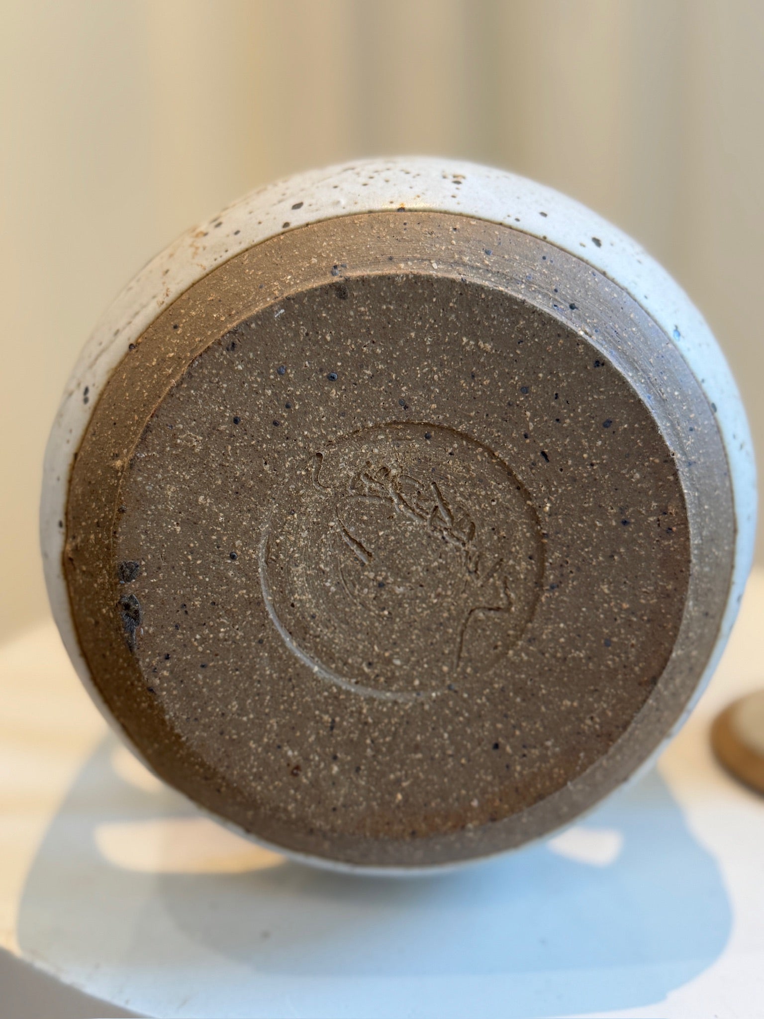 Bottom view of Sculptural Studio Pottery Vase with Lid and Organic Cutouts showcasing speckled stoneware texture and craftsmanship. hommes + gardens estudio