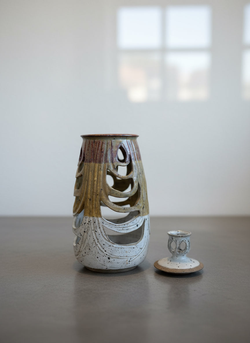 Sculptural Studio Pottery Vase with Lid and Organic Cutouts showcasing intricate piercings and layered glazes. hommes + gardens estudio.