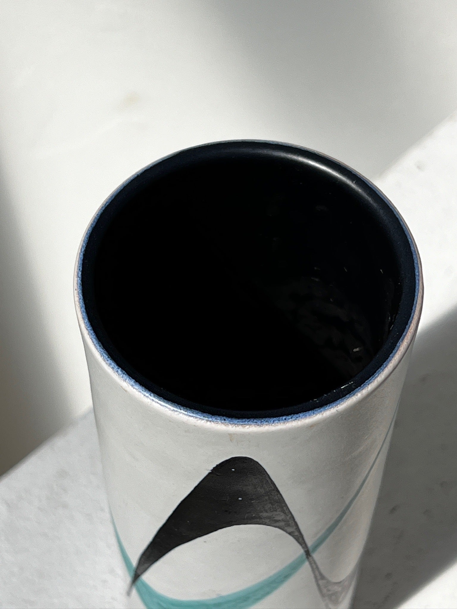 Swiss mid-century modern Müller Lucerne ceramic vase featuring hand-painted black and teal motifs on white matte surface, sleek cylindrical form — Hommes and Gardens, Vases + Vessels Collection, Landscape Architect, Interior Designer, Outdoor Living, Art, Furniture, Objects, Best Gifts, Nature, Backyard, Yard, Outdoor Decorations, Home Decor, Home Design, Luxury Design.