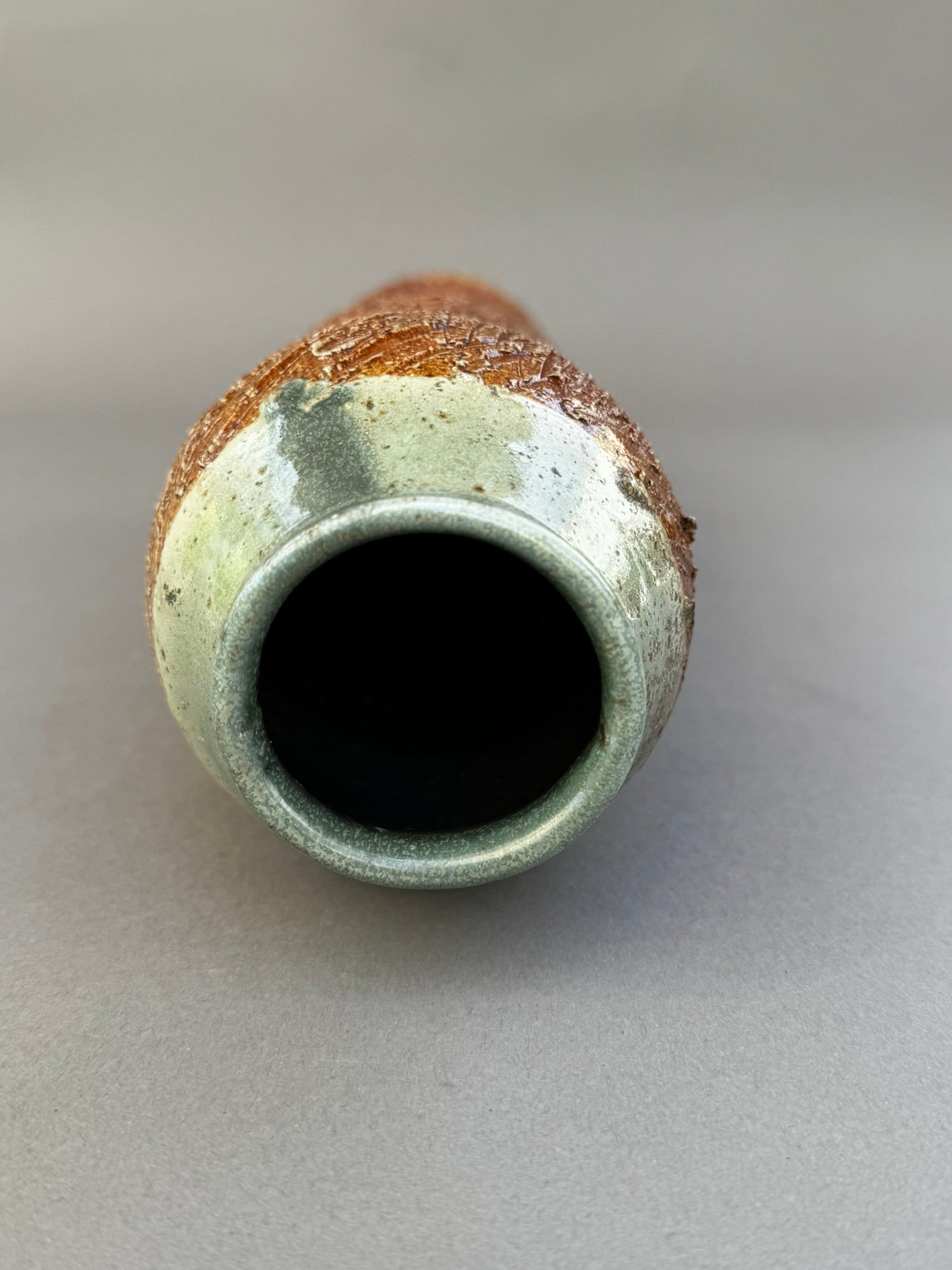 Tall Textured Studio Pottery Vase with Glazed Rim – Signed Ceramic Art Piece, showcasing rich textures and glossy glaze. hommes + gardens estudio.