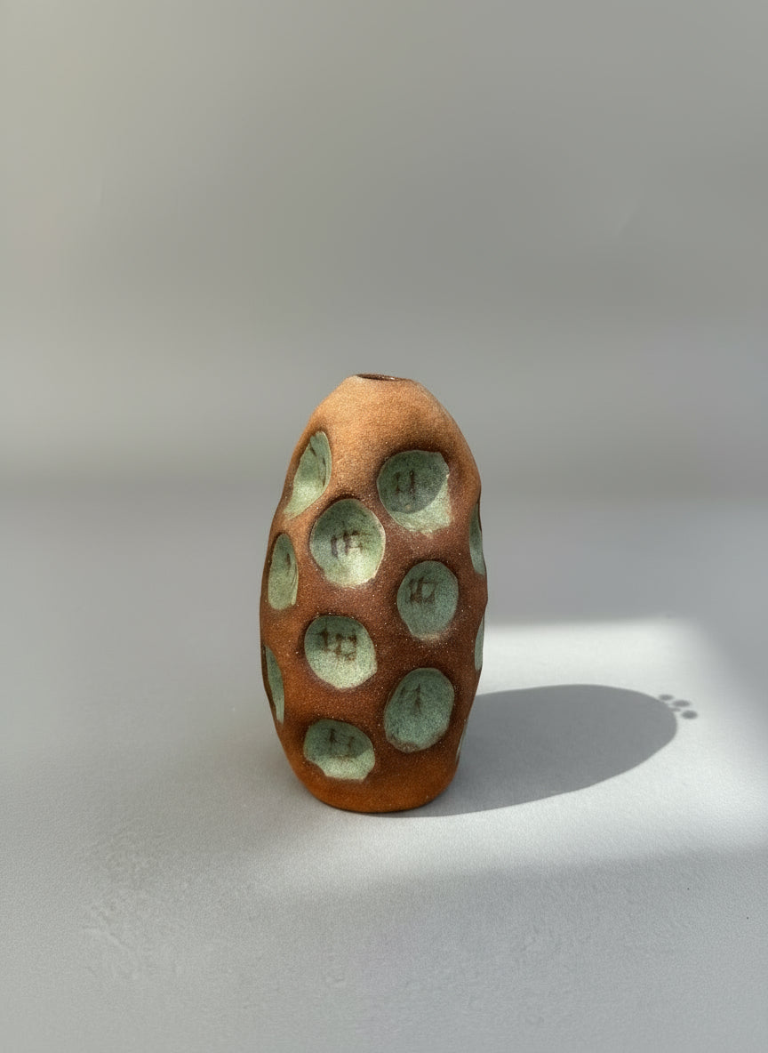 Handmade Terracotta Glazed Studio Pottery Bud Vase with Celadon Impressions, featuring unique circular recesses, hommes + gardens estudio.