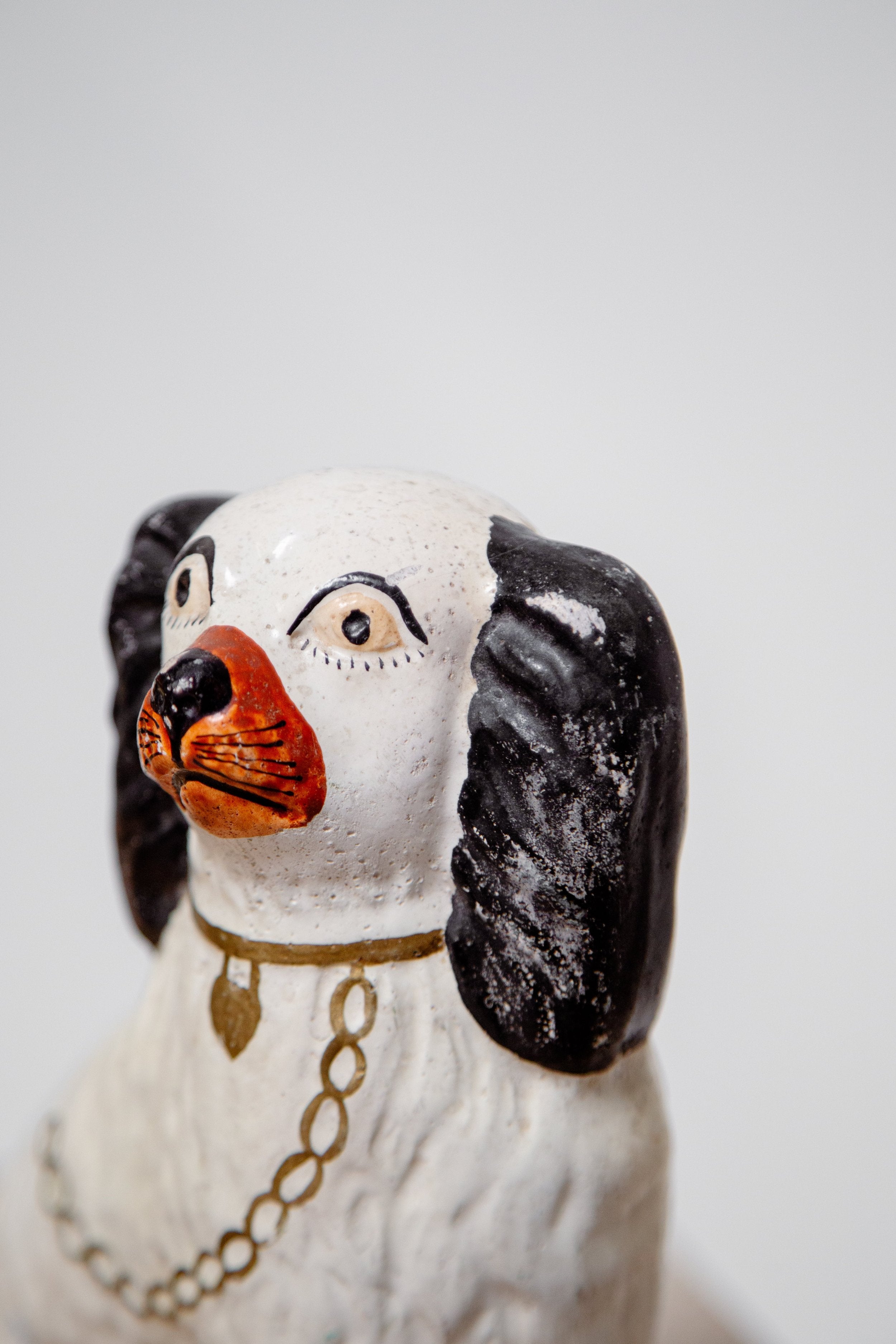 Close-up of Victorian Pair of Staffordshire Dog Figurines showcasing detailed hand-painting and craftsmanship. hommes + gardens estudio.