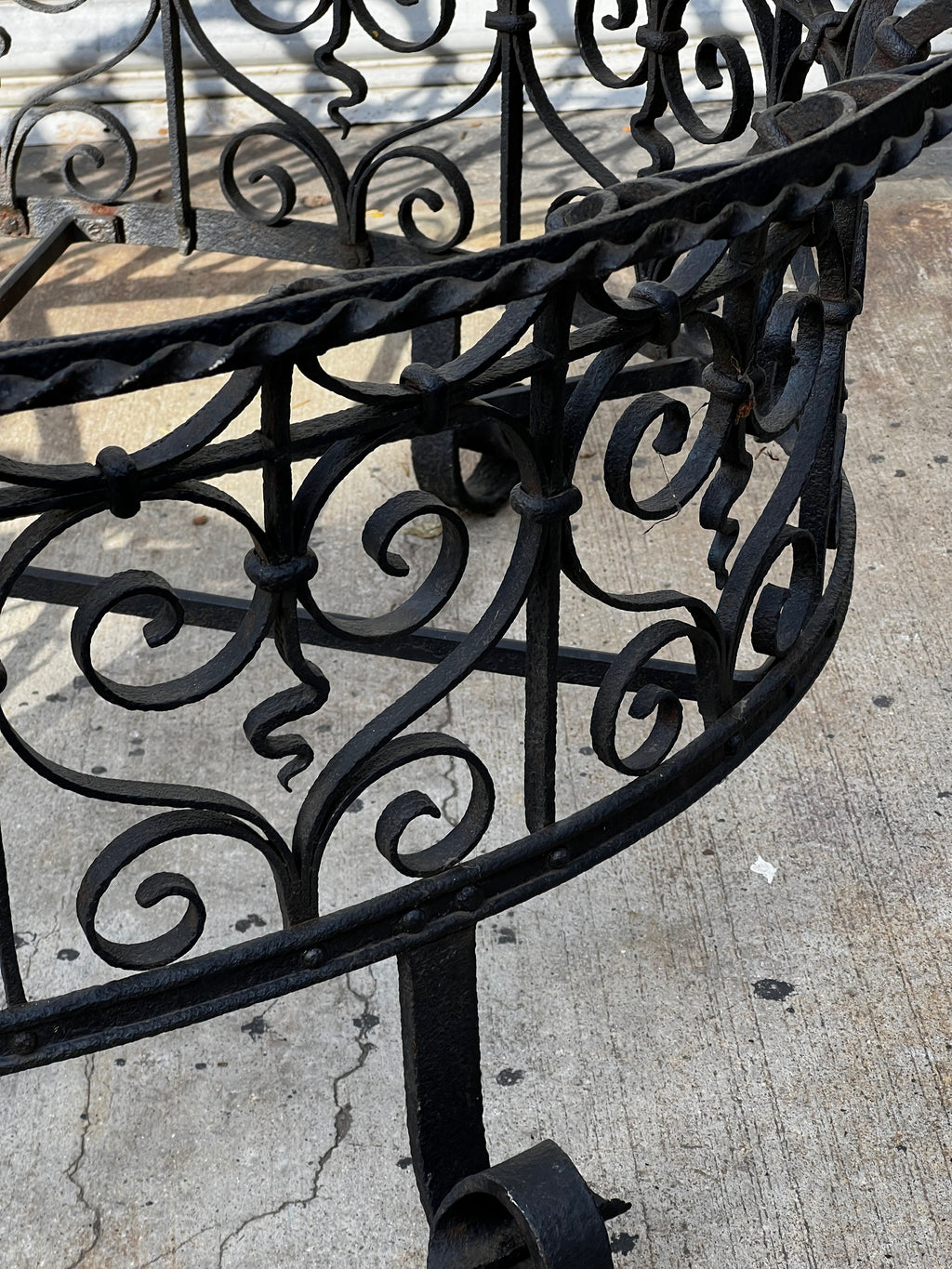 Detail of decorative scrollwork on a Victorian Oval Wrought Iron Plant Holder at hommes + gardens estudio.